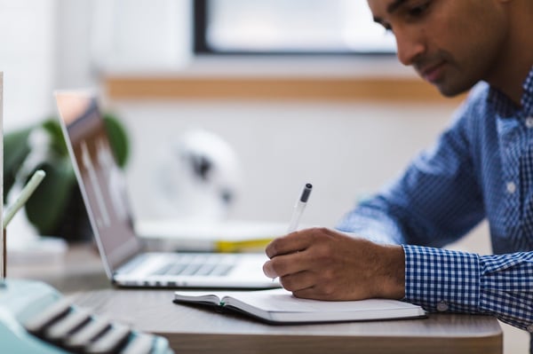 Man carrying out research using his laptop